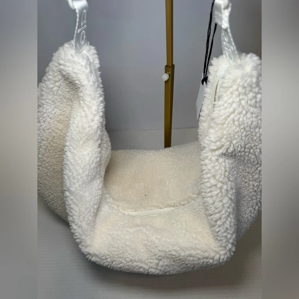 Alo Yoga Sherpa On The Go Sling Bag in ivory